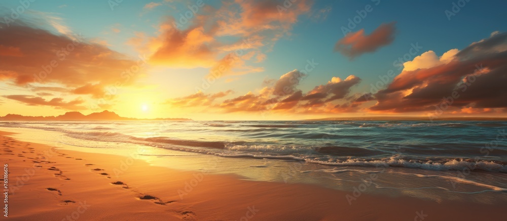 Canvas Prints A serene sunset over the sea with sandy footprints