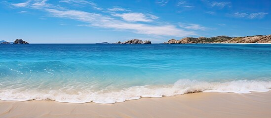 Rocky island in a clear blue beach panorama
