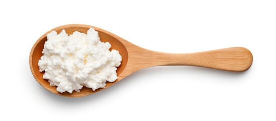 Wooden spoon with cottage cheese on white