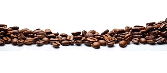 Coffee beans arranged in a pile on a white surface