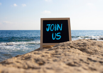 Join us symbol. Concept word Join us on black chalk background. Beautiful sea background. Business...