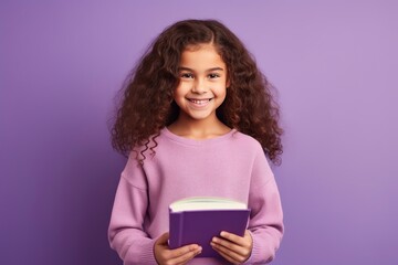 Photo of optimistic happy little girl hold read book study wear pullover isolated on violet color background - generative ai