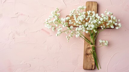 Wooden cross and white flowers on a plain background, banner for Catholic Easter