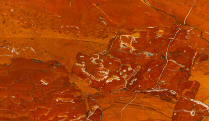 red marble texture with black veins and white splashes close-up