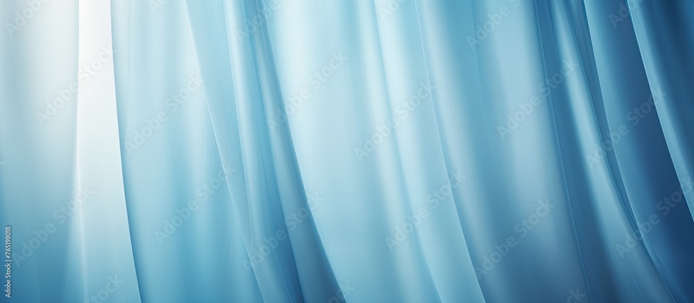 Poster an image showing a blue curtain in close-up with a bright light shining through it