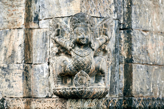 Bas relief mythical female creature from Tibetan folklore in Pashupatinath Temple in Kathmandu, Nepal, symbolizes divine femininity and adding spiritual dimension to sacred space
