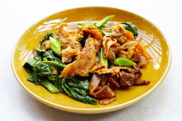 Stir-fried rice noodles with soy sauce and pork