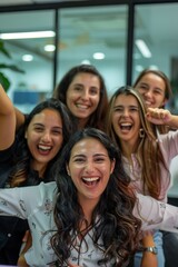 Fototapeta premium group of smiling business women celebrating happily
