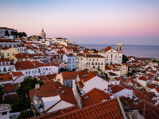 Stunning sunset over the old town of Lisbon from Miradouro das Portas do Sol, Portugal - 765213857