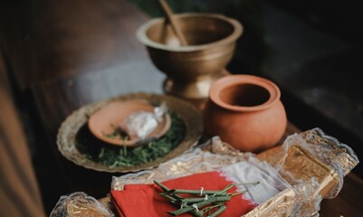 Handmade ceramic craft utensils. Rustic napkins and kitchen utensils. Jug with dried leaves tied on a red cloth. handmade jug.