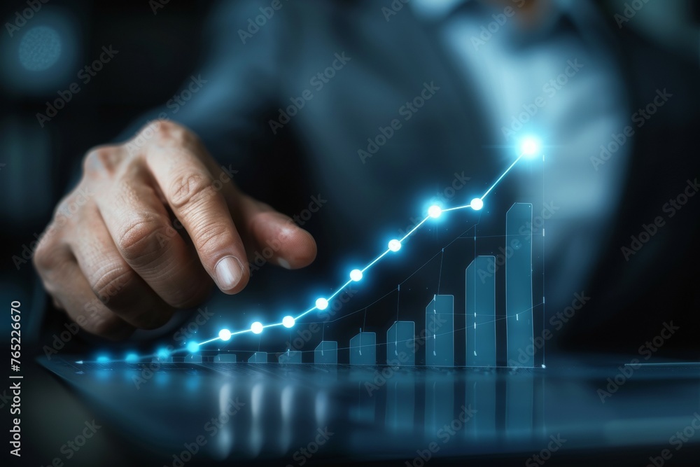 Poster a man is pointing at a graph on a computer screen
