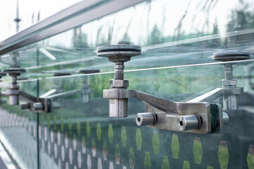 transparent glass roof  with steel mounts bolted fixed to transparent wall, modern architecture rimless close-up, nobody.