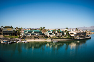 Fototapeta premium Lake Havasu AZ - March 5th, 2024: Tour boats near the old London Bridge, which was relocated from London England in the 1970’s to Lake Havasu Arizona.