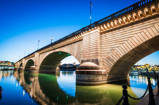 Tourists near the old London Bridge at sunset, which was relocated from London England in the 1970&rsquo;s to Lake Havasu Arizona.