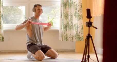 Fitness trainer during online workout session at home. Utilizing technology as smartphones and video conferencing platforms, participants engage in virtual fitness sessions from any location.