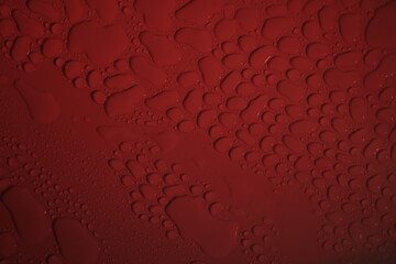 close up of water droplets on red background, macro photography, shallow depth of field, blurry background, water drops
