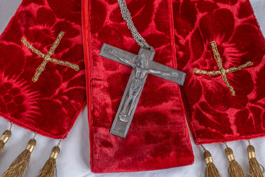 Ecclesiastical red scarlet vestments, paraments, stole, crucifix for Holy Week, Palm Sunday, Pentecost, Maundy Thursday, & church Festivals with gold crosses displayed.