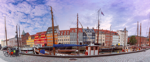 Panorama of Nyhavn with colorful facades of old houses and ships in Old Town of Copenhagen, Denmark. - 765249813