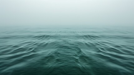 Fototapeta na wymiar Misty Ocean Scene: Green Toned Seascape with Gentle Waves