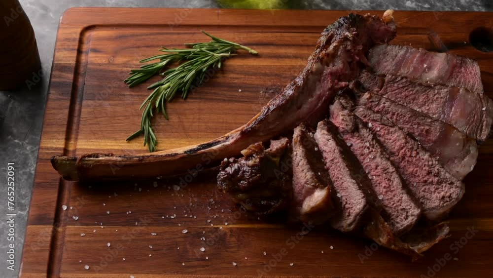 Wall mural sliced tomahawk steak on wooden board