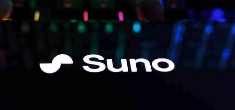 Viersen, Germany - March 9. 2024: Closeup of Smartphone with logo lettering of AI music generator Suno on computer keyboard