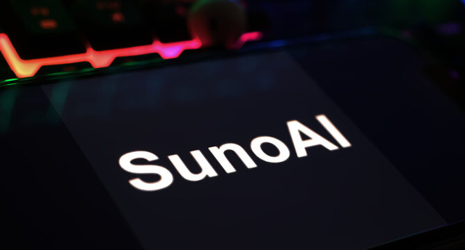 Viersen, Germany - March 9. 2024: Closeup of Smartphone with logo lettering of AI music generator Suno on computer keyboard