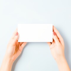 Man holding a blank white card in his hands