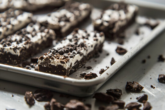 Close-Up Freshly Made Cookies And Cream Protein Bars On Steel Tray In Restaurant Interior, Protein Bars Food Photography, Food Menu Style Photo Image