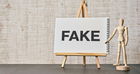 There is notebook with the word FAKE. It is as an eye-catching image.