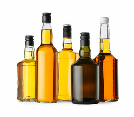 Different sorts of whiskey in glass bottles isolated on white