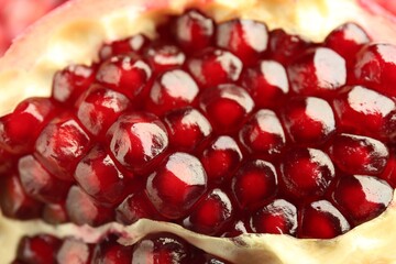 Ripe juicy pomegranate grains as background, closeup
