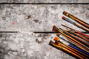brushes on an artist's table as a canvas for an advertisement - artisan concept