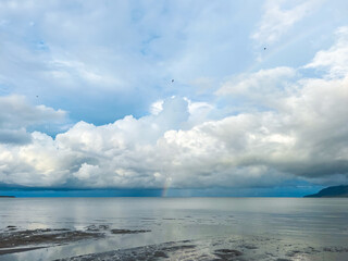 clouds and rainbow over the sea