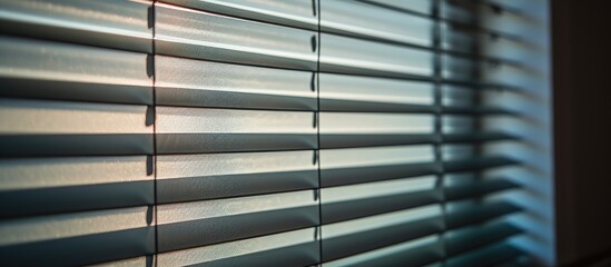 Blinds are shut, but beams of light are filtering through the closed slats.