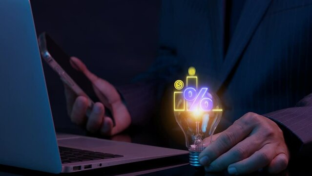 Profit high growth percent icon, stocks, financial, Interest rate and dividend concept. Businessman showing glowing lightbulb and animation of dollar sign graph and chart with percentage icon.