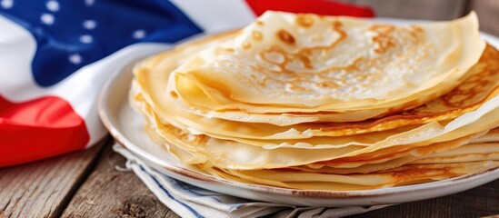 A stack of thin crepes served on a plate and placed on the dining table for breakfast