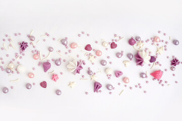 Sweet lilac sprinkles scattered on white background