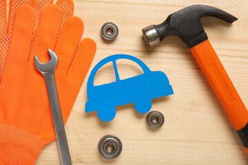 Set of mechanic tools and paper car on wooden background, closeup. Mechanic concept