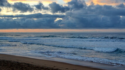 Waves breaking on the beach at sunrise, in Zipolite, Mexico