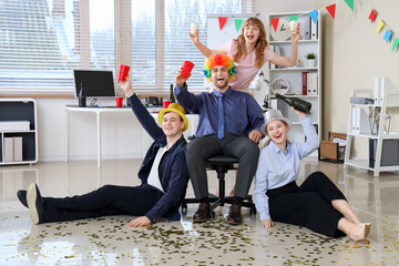 Business people with champagne celebrating April Fools' Day at office party