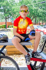 Casual portrait of a youth cyclist sitting down cooling off after a race
