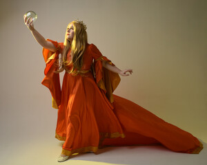 Full length portrait of plus sized woman blonde hair, wearing historical medieval fantasy gown,...