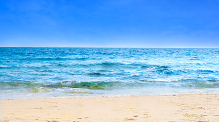 background for summer vacation concept. Nature of the beach and sea, summer with sunlight, sandy beach The sparkling sea water contrasts with the blue sky	