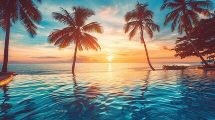 Fototapeta na wymiar Palm trees and swimming pool at tropical resort beach on sunset