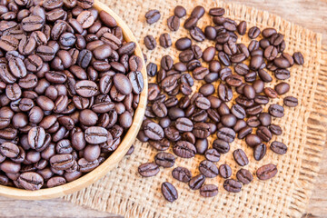Roasted coffee beans in a wooden bowl