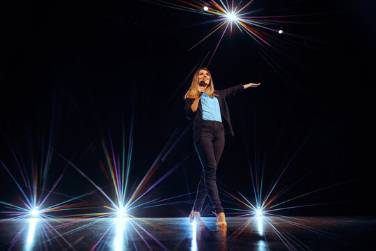 Motivational Speaker Talking on a Stage with Charisma and Elegance. Charismatic leader expressing herself with energy and persuasion 