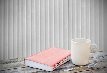 Notebook and coffee cup on wood table