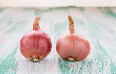 Organic red onion on wooden background