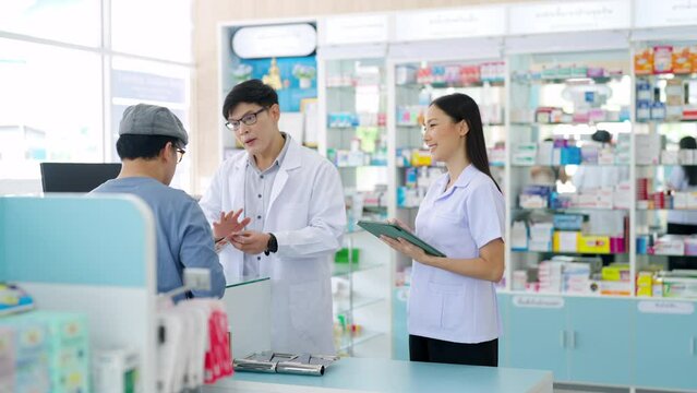 Medical pharmacy, hospital clinic and healthcare providers concept. Asian woman pharmacist medication recommendation about medicine, drugs and supplements to male patient customer at modern drugstore.