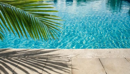 Fototapeta na wymiar tropical summer background with concrete wall pool water and palm leaf shadow